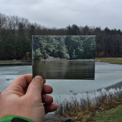 Holding up a old picture of the lake to match what we see now.